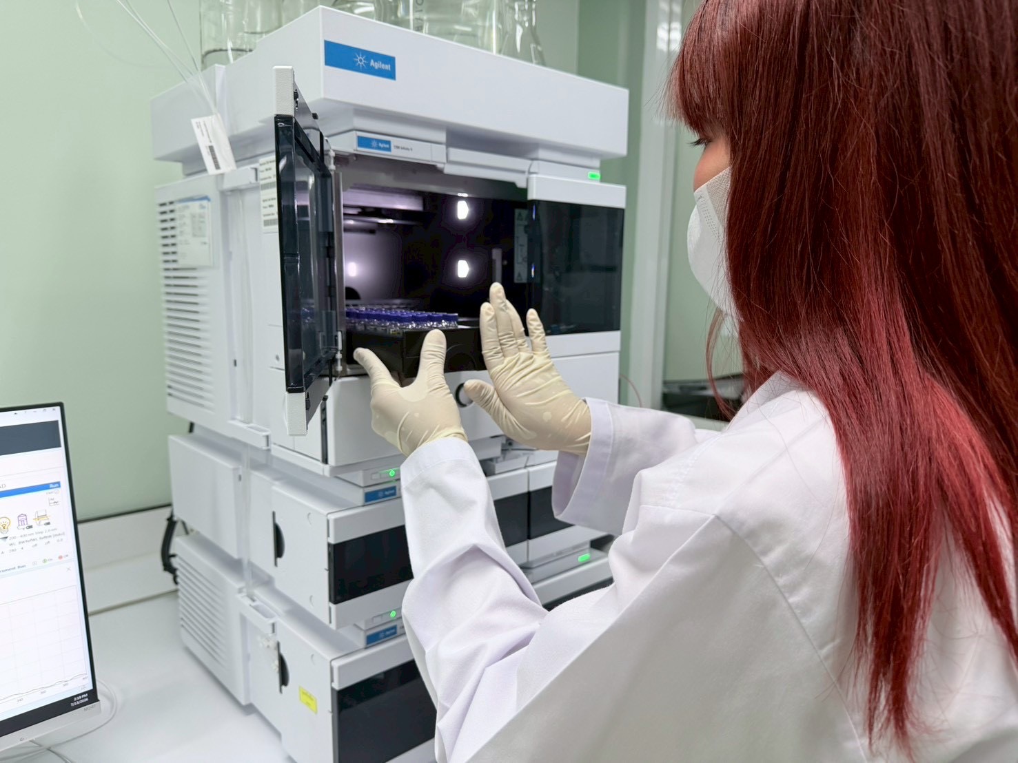 Analyst loading sample vials at a partner pharmaceutical laboratory
