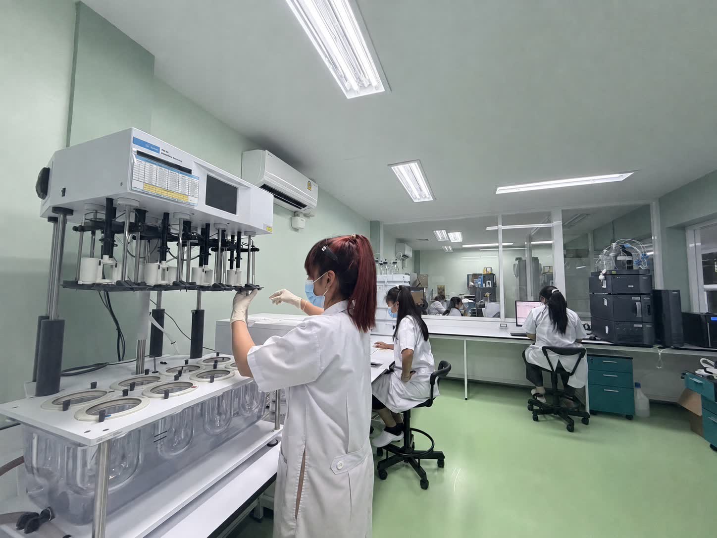 Scientists working at laboratory benches in our pharmaceutical manufacturing facility